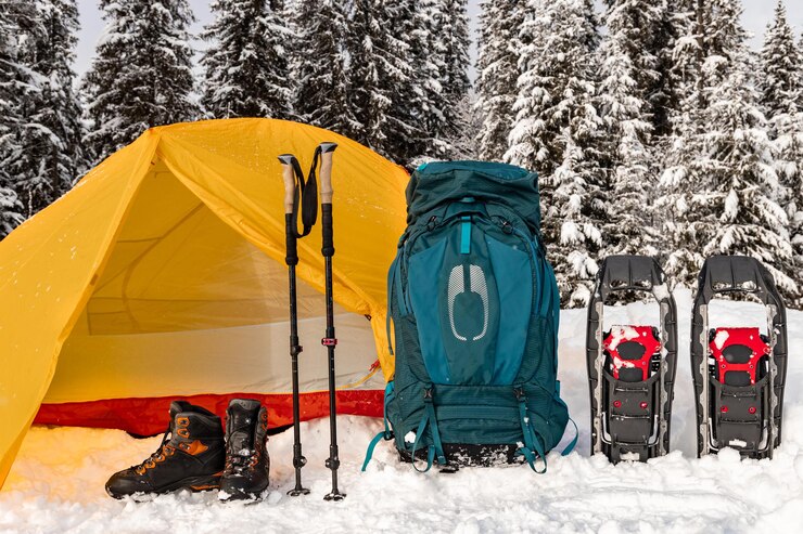 Cold Comfort: A Camping Guide to Snowy Survival 2025 3 camping-mountains-with-backpack-tent-snowshoes-hiking-equipment